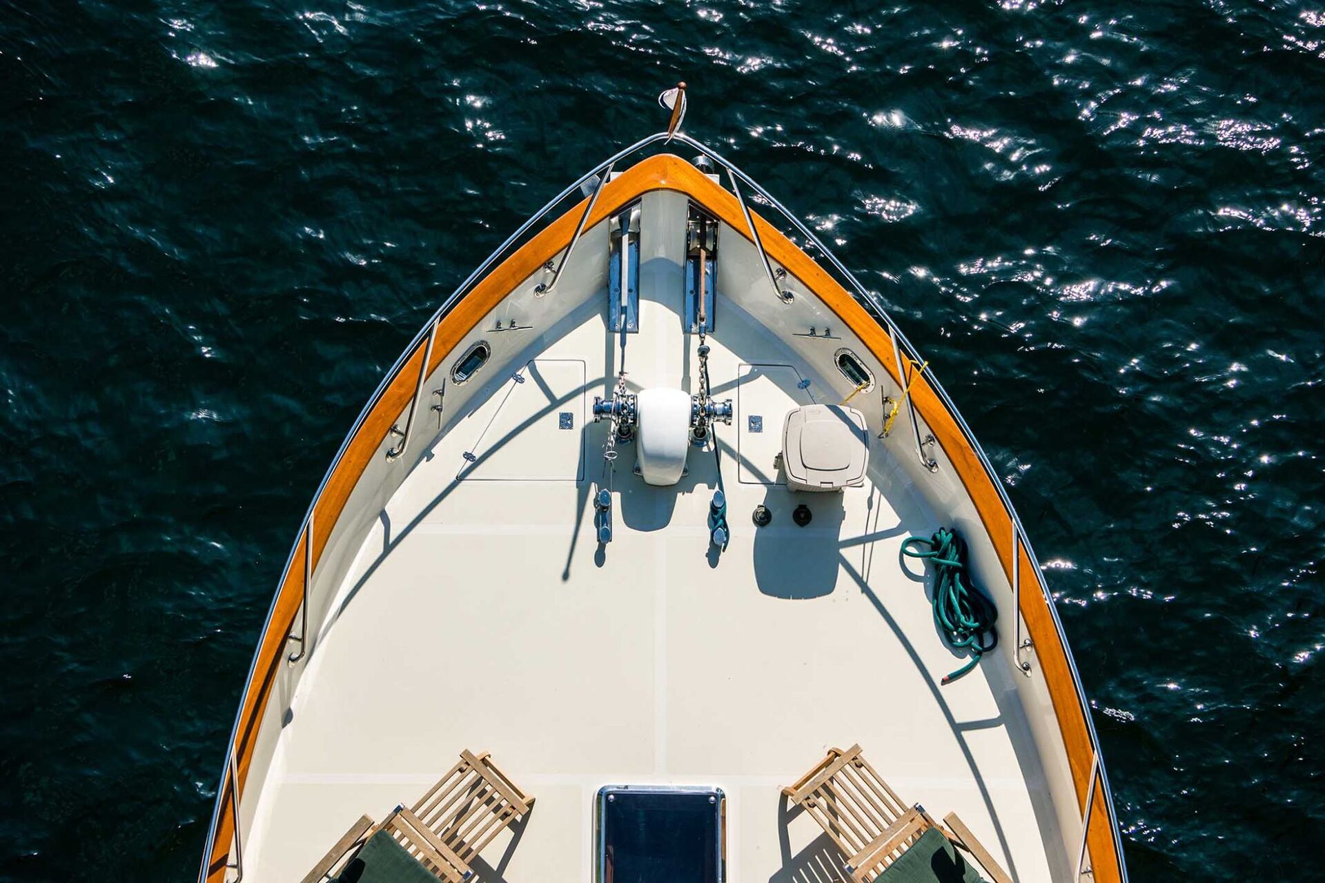Bow of a classic motor yacht on dark open water