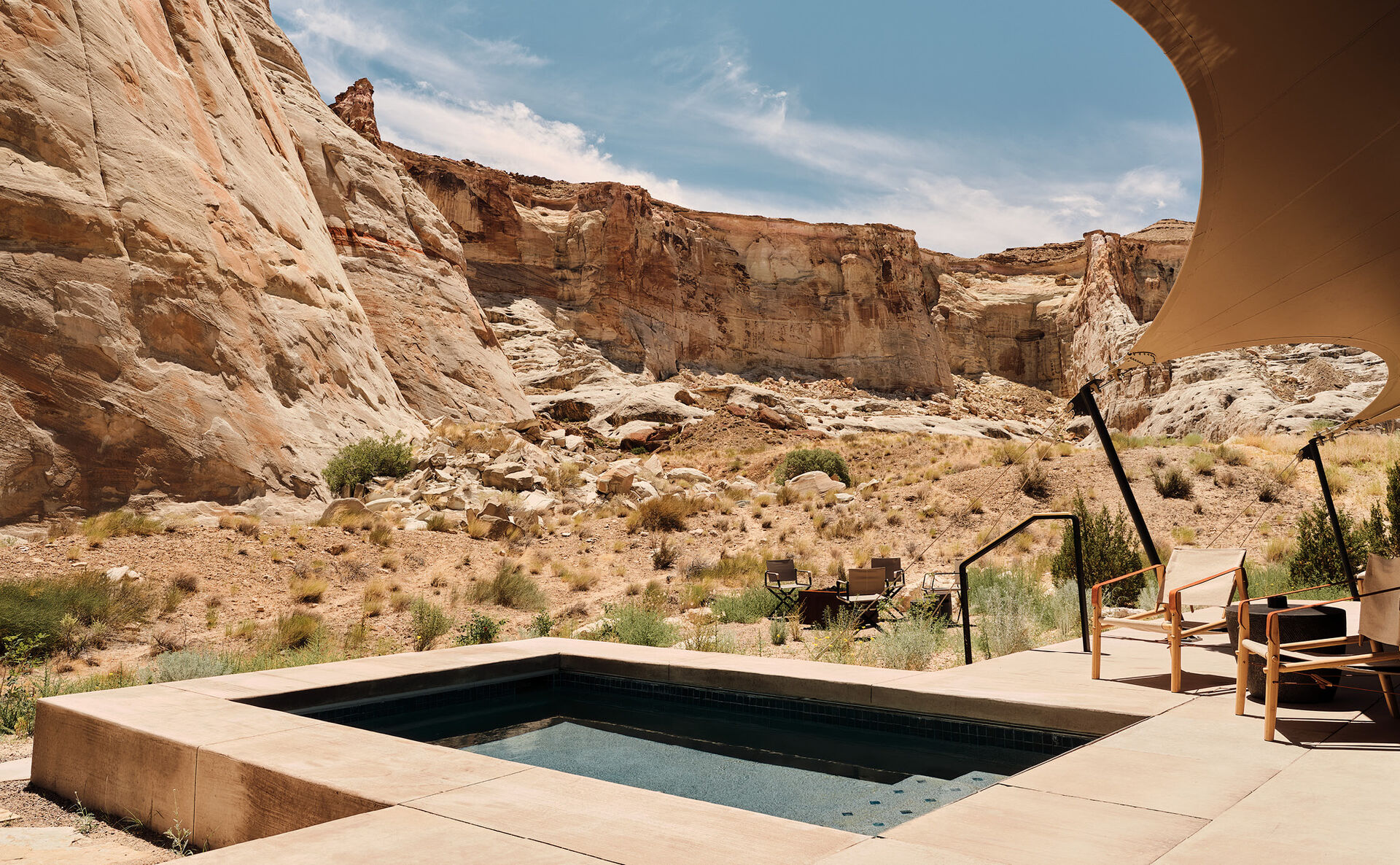 A private desert retreat pool beneath sandstone cliffs